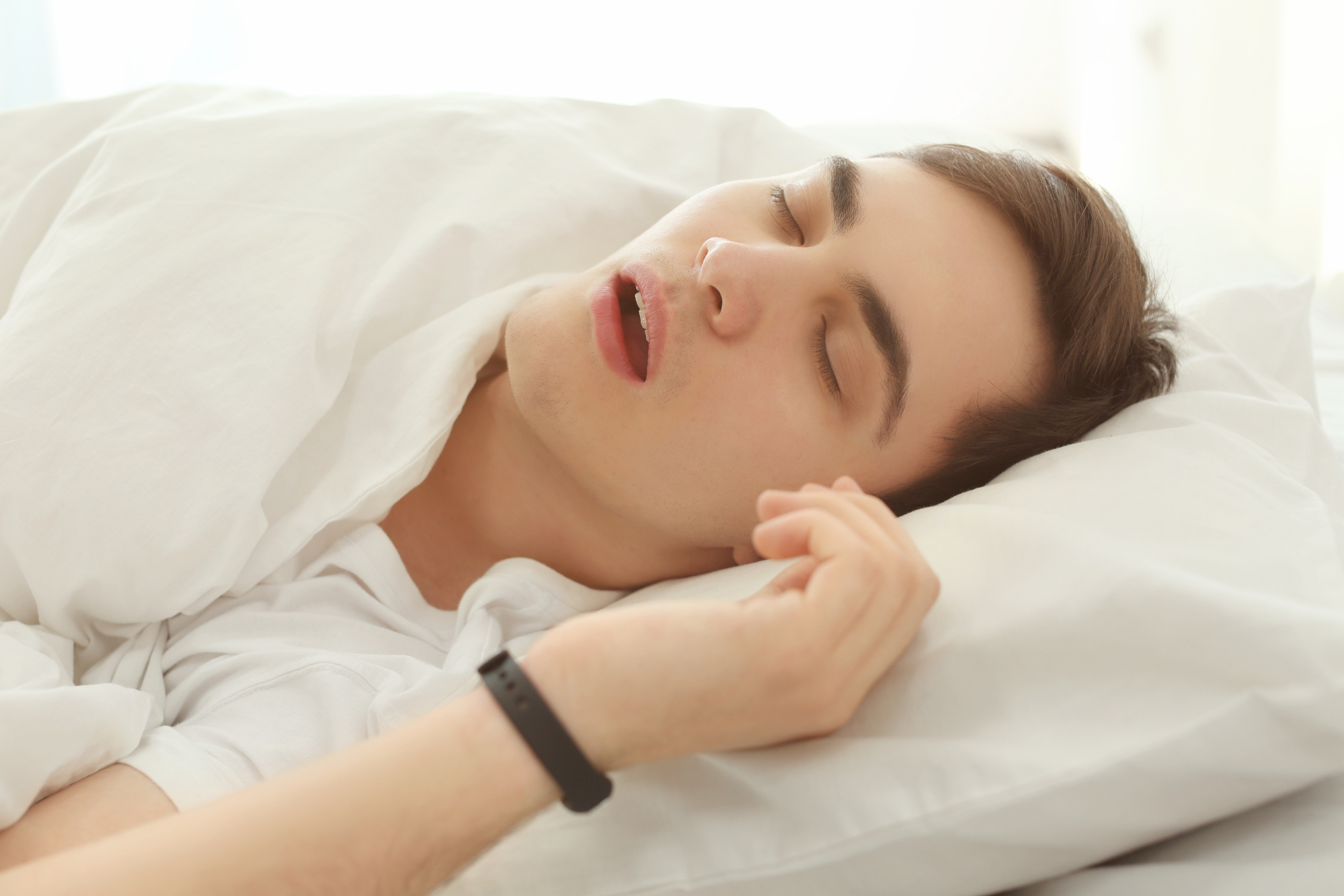 person wearing sleep tracker to bed