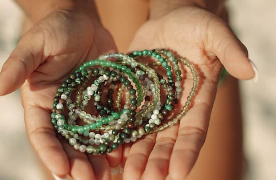 holding green bracelet