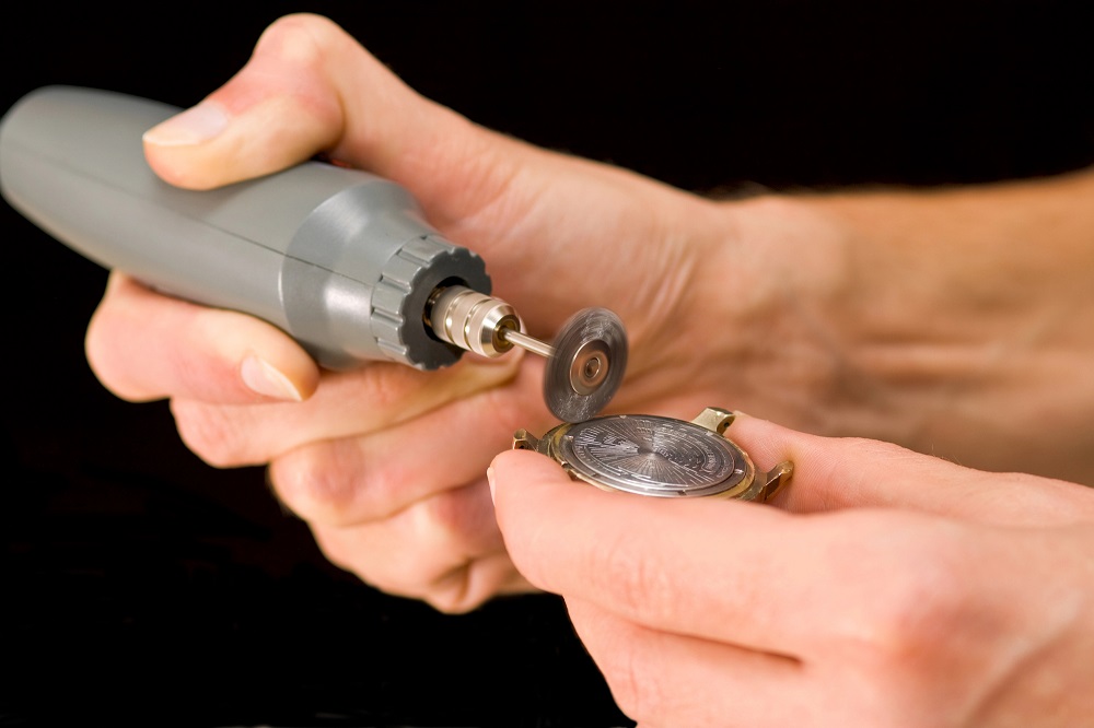 man polishing old watch