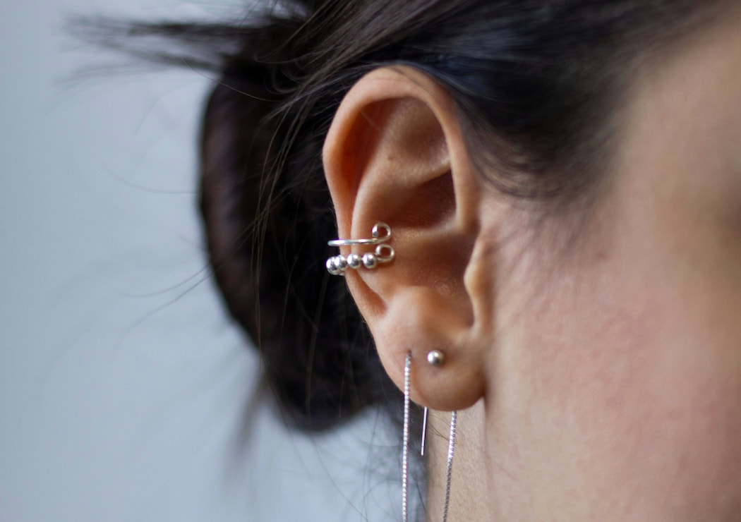 woman wearing multiple earrings