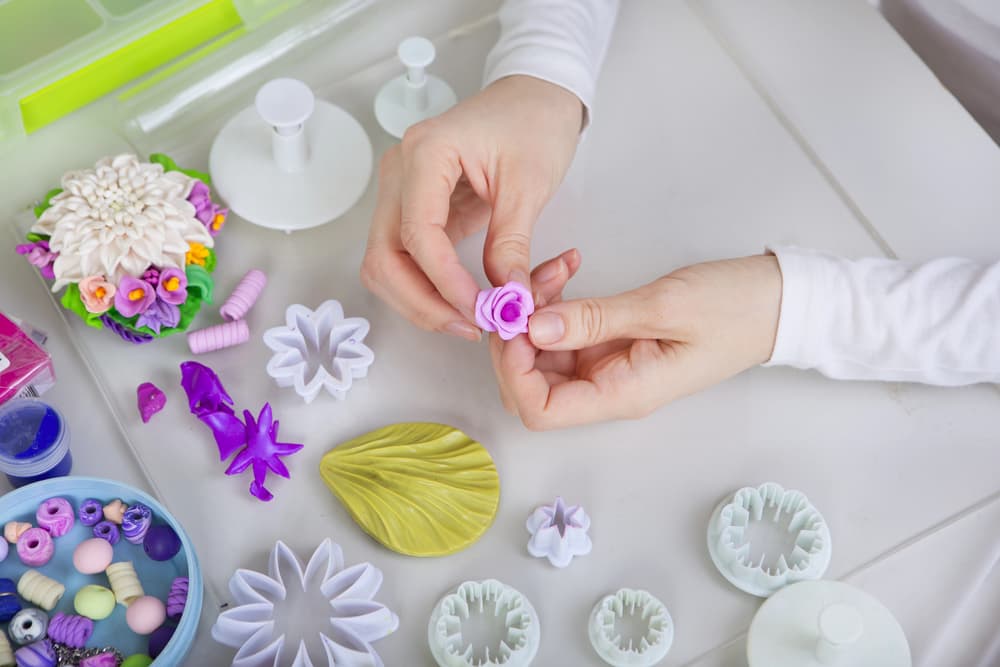 artist making polymer jewelry