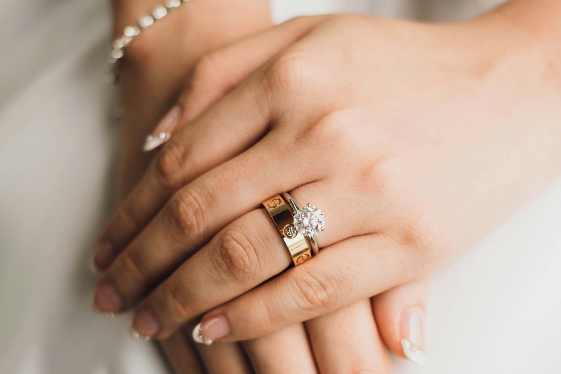 a cartier love ring on hand