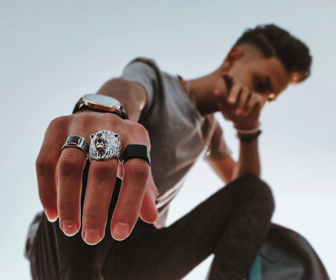 man wearing multiple rings