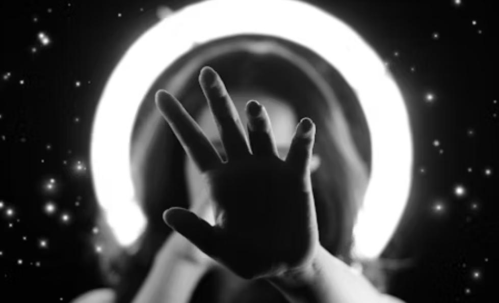 a hand reaching out from the starlight