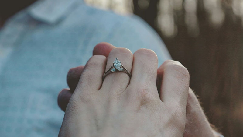 an engagement ring on the finger