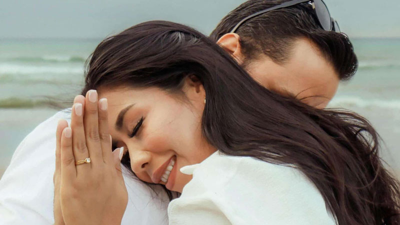 couple hugging with a promise ring on finger