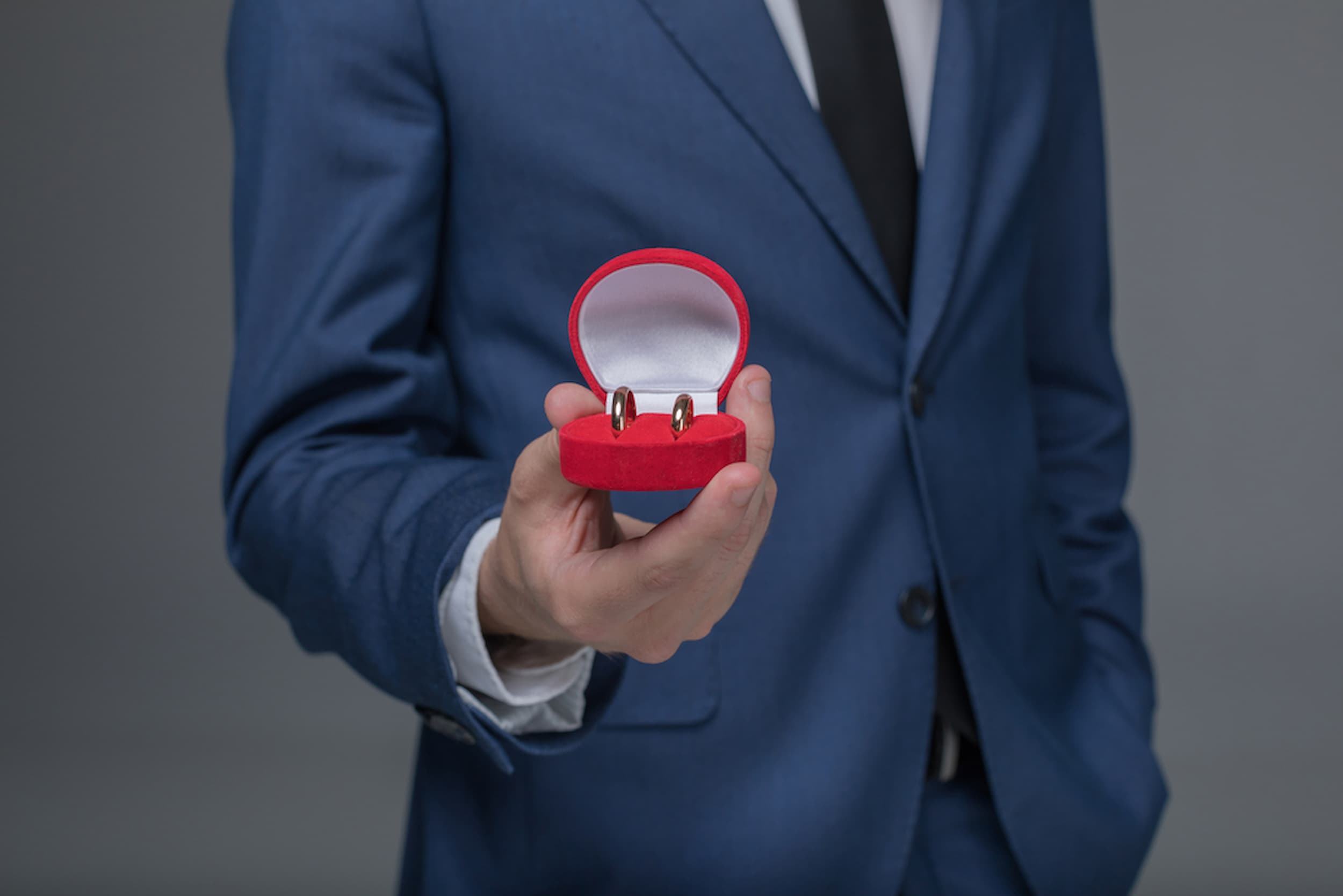 man holding wedding rings