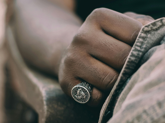 man wearing signet ring on pinky